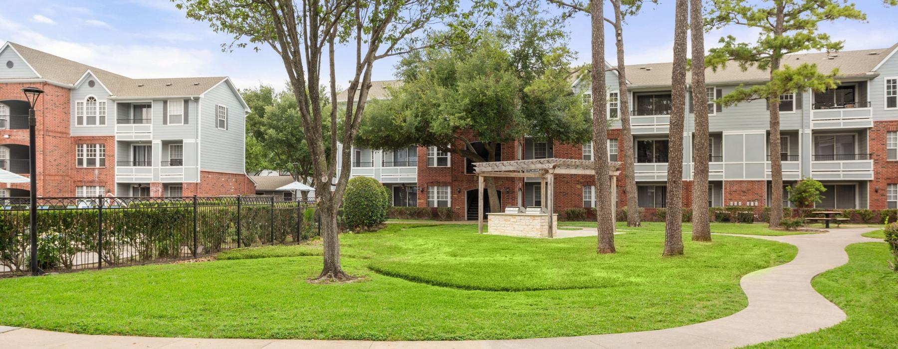 a group of buildings with trees in front of them